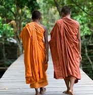 monks walking across a bridge at Beng Milea Temple