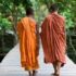 monks walking across a bridge at Beng Milea Temple